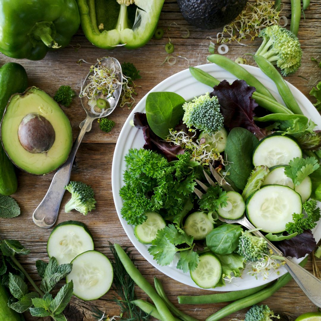 A table full of salad and fiber rich foods.