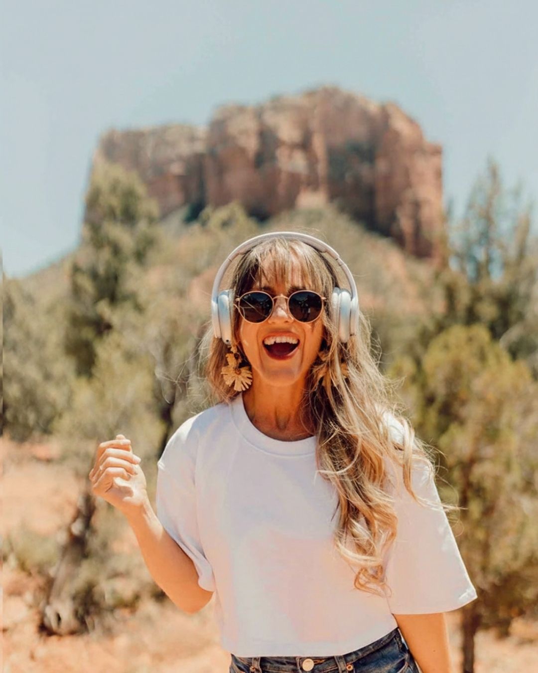 Image of Sammy out in the desert wearing glasses and headphones