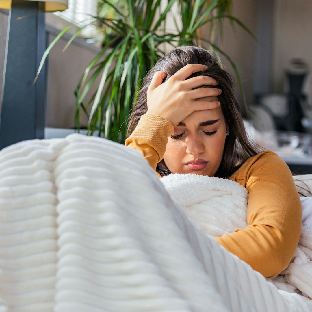 A woman sick in bed.